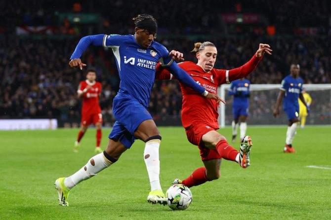 Chelsea's Noni Madueke in action with Liverpool's Kostas Tsimikas 