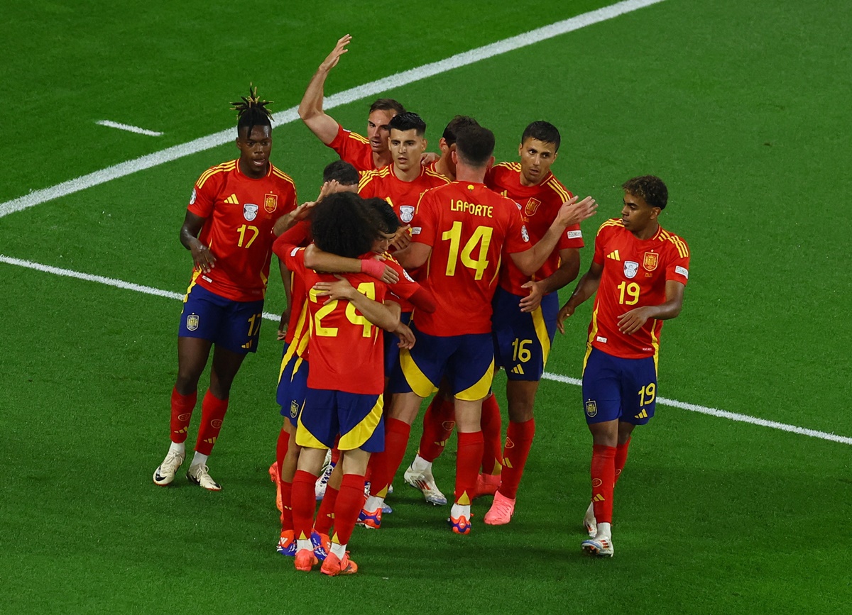 Spain's players celebrate after the own goal by Riccardo Calafiori.