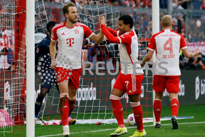 Bayern Munich's Harry Kane celebrates scoring their seventh goal with Serge Gnabry to complete his hat-trick against 1. FSV Mainz 05 at Allianz Arena, Munich, Germany