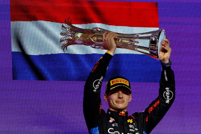 Red Bull's Max Verstappen celebrates with a trophy on the podium after winning the Saudi Arabian F1 Grand Prix at Jeddah Corniche Circuit, Jeddah, Saudi Arabia on Saturday 