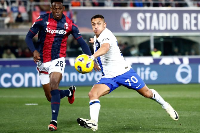 Inter Milan's Alexis Sanchez in action with Bologna's Jhon Lucumi during the Serie A match at Stadio Renato Dall'Ara, Bologna, Italy 