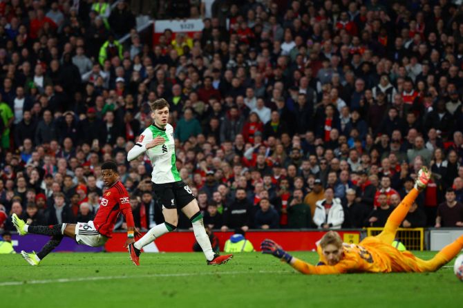 Manchester United's Amad Diallo scores the late winner and their fourth goal past Liverpool's Caoimhin Kelleher 