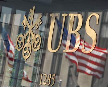 The US flag is seen in a reflection outside the Swiss bank UBS offices in New York.