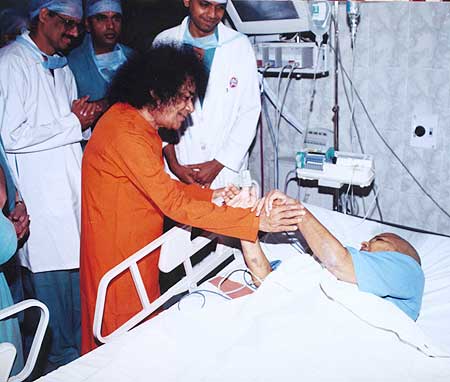 Sri Sathya Sai Baba with a patient