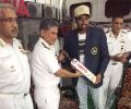 Ashwin enjoys a cup of coffee with naval officials following Vizag Test win