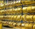 Gold slips from record on weak global trend; down by Rs 230