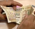 Rupee see-saws; state banks' dollar buying, weak shares hurt