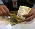 Rupee dips as shares remain under pressure