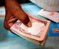 Rupee falls for second day; oil companies buy dollars