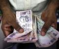 Rupee slips 5 paise to close at 67.11/USD