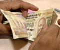Rupee firms up by 14 paise, ends at 67.07