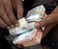 Rupee trims initial losses, trade almost flat vs USD