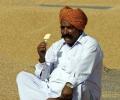 Who originally coined the 'acche din' slogan?