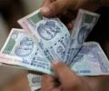 Rupee climbs to 2-week high against dollar, up 11 paise