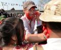 PHOTOS: Britain's Prince Harry sees red during Holi in Nepal