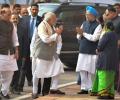 Amid war of words, Modi shakes hands with Manmohan Singh