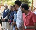 Modi votes in Gujarat, takes a walk with inked finger for crowds