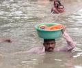 Vadodara cop carries baby in tub on his head in neck-deep water