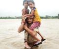 Guj cop carries 2 children on shoulders in floodwater