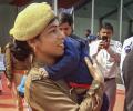 Infant son in her arms, UP cop performs duty at Yogi's event