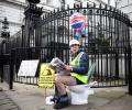 Why is he on a potty outside British PM's home?