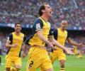 Atletico win La Liga title after draw at Barca