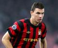 Dzeko heads gritty Man City clear at top