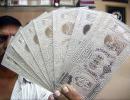 Rupee breaches 64-level, recovers after RBI steps in