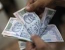 Rupee gains 13 paise to end at 1-week high against dollar