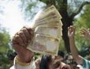 Rupee ends lower as dollar demand offsets shares recovery