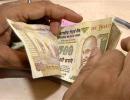 Rupee firms up by 14 paise, ends at 67.07