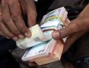 Rupee trims initial losses, trade almost flat vs USD