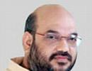 Gujarat Home Minister Shah quits, eludes arrest