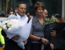 Australian PM Tony Abbott lays flowers at Sydney siege site