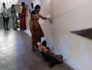 Denied stretcher, woman drags husband on hospital ramp