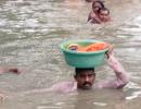 Cop carries baby in tub on his head in neck-deep water