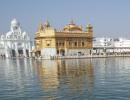 Woman with tiranga on cheek stopped at Golden Temple