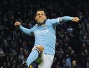 Tevez double sends Man City atop table