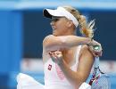 Glam girls Wozniacki, Sharapova record easy wins