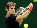 Rampant Federer crushes Davydenko, Nadal toils in Doha