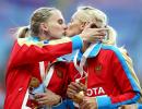 Russia's golden girls protest anti-gay law with podium kiss