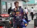 Vettel secures pole at rain-hit Sepang