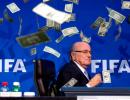 PHOTOS: Protester showers FIFA's Blatter with fake money