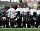 PHOTOS: NFL players defy Trump; link arms in solidarity