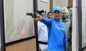 First Look: Dhoni goes shooting after practice washed out