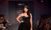 Black magic! Rhea casts a spell in layered gown