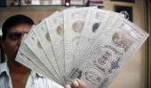 Rupee breaches 64-level, recovers after RBI steps in