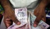 Rupee trims initial gains vs dollar