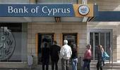 Cyprus reopens banks under tight restrictions