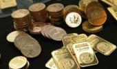 Gold ticks up, heads for second straight weekly gain